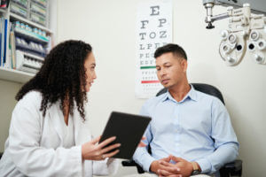 optometrist talking to a patient about eye care