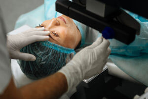 An adult woman undergoing a laser treatment similar to Bladeless LASIK eye surgery for vision correction.