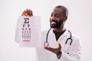Image of an eye doctor holding a vision examiner.