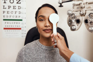 A coloured woman undergoing sight test during her Eye Exam at the clinic.