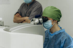 Doctor performing ustom LASIK eye surgery using medical microscope.